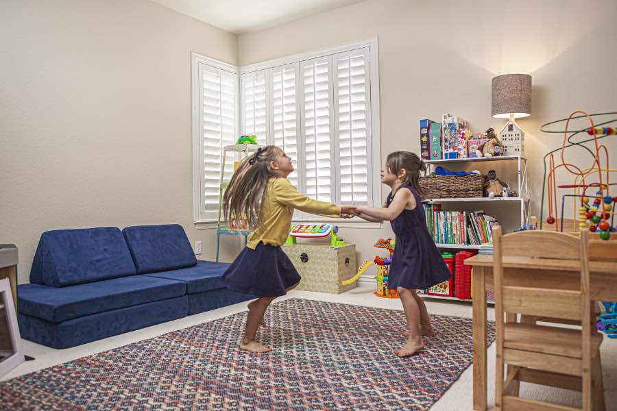 Choose Polywood shutters for durable, kid-friendly great room window treatments in Cincinnati. Polywood shutters on multiple windows in a sitting area