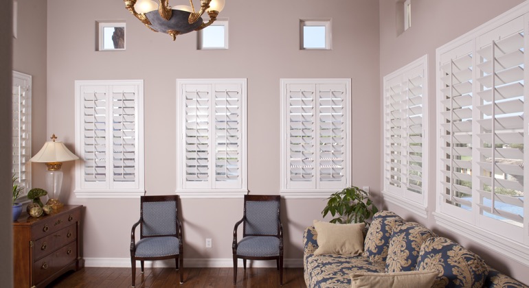 Chic sunroom with classic shutters