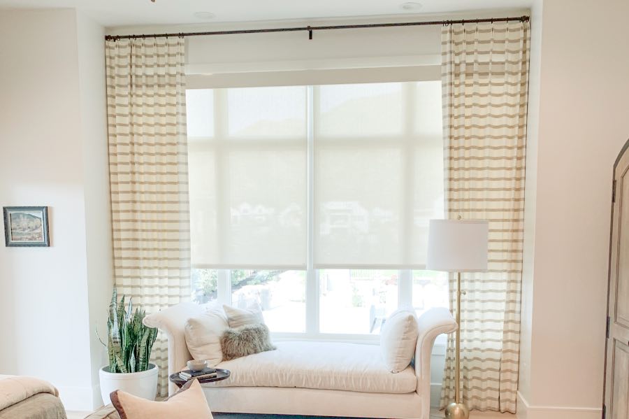 White motorized shades on a large bedroom window