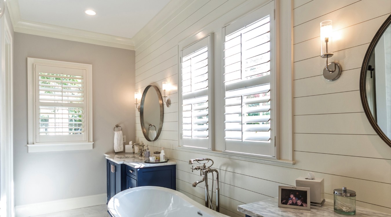 Cincinnati bathroom with white plantation shutters.