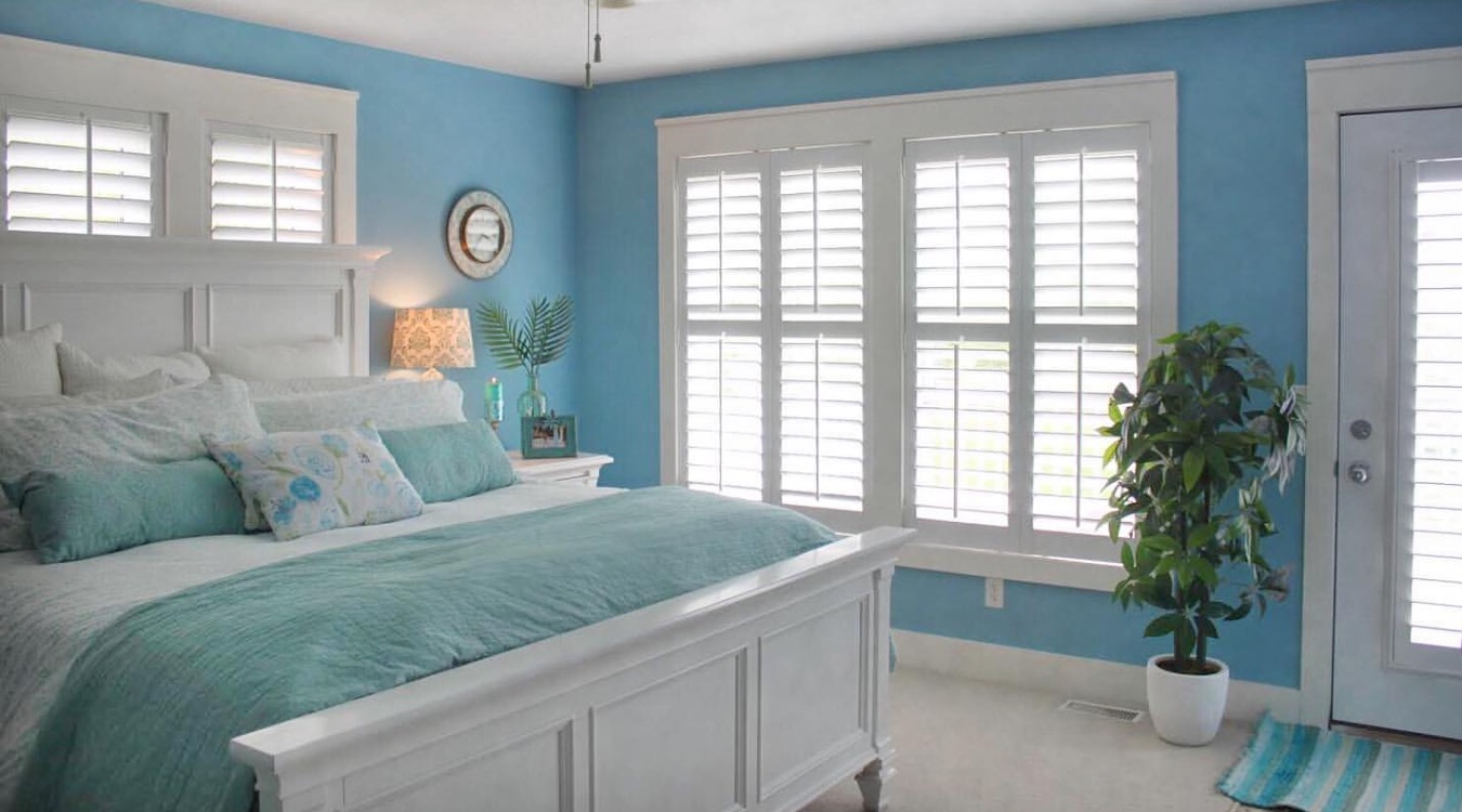 Blue bedroom with plantation shutters