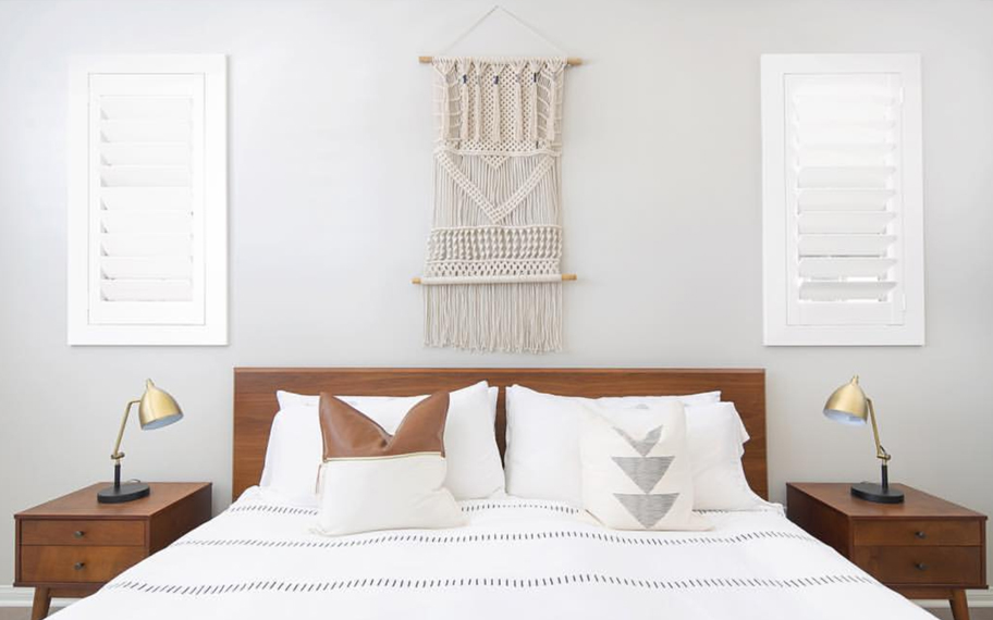 Custom-fitted louvered shutters provide excellent nighttime privacy in Cincinnati. Photo Credit: Audrey Crisp Louvered shutters in a bedroom.