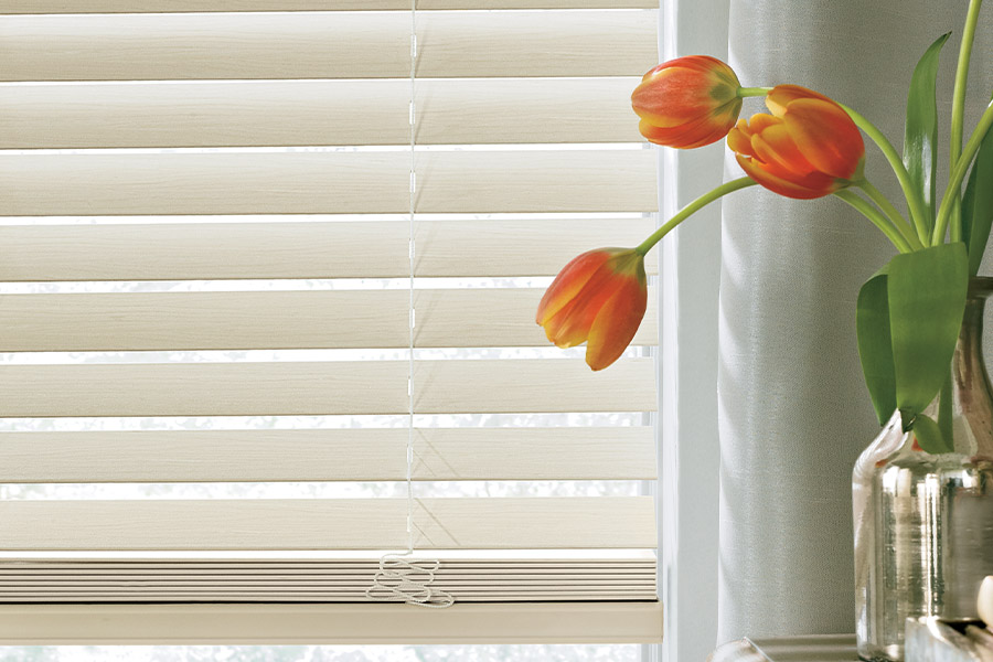 White wood blinds up close in a living space