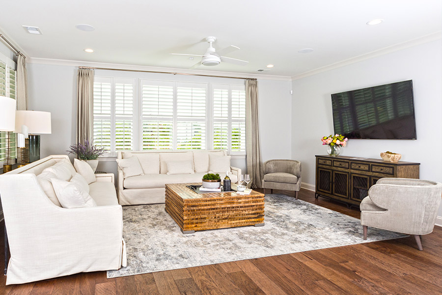 Large media room with white Polywood shutters.