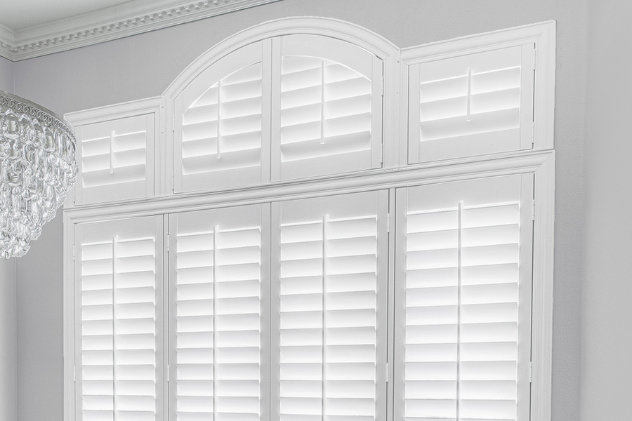 Customize your Palladian windows with white Polywood shutters in Cincinnati. White Polywood Palladian windows in a dining room.