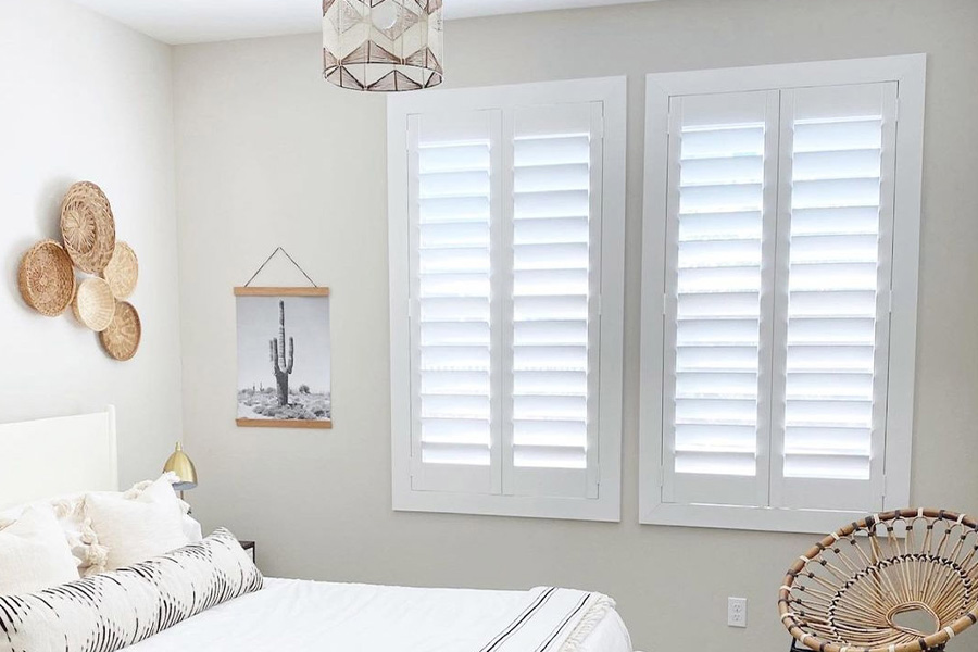 White polywood shutters in a white bedroom.