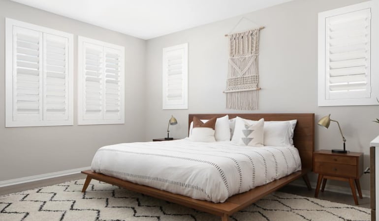 Open shutter louvers will help any Cincinnati room feel larger. Plantation shutters in a model home bedroom.