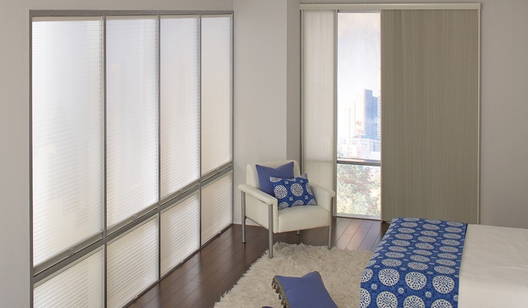 Cell shades are another option to reflect a minimalist design. Cellular shades in a modern bedroom.