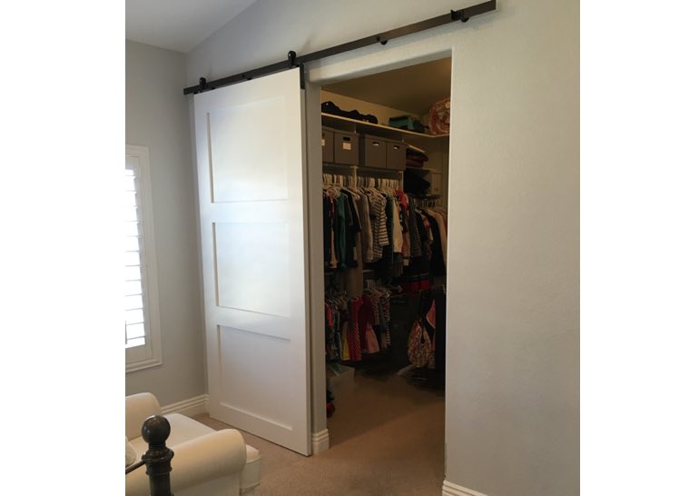 White barn door used as closet door
