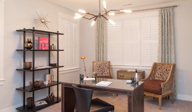 Picking the right window treatments can result in an increase in natural light. Cincinnati home office with plantation shutters.