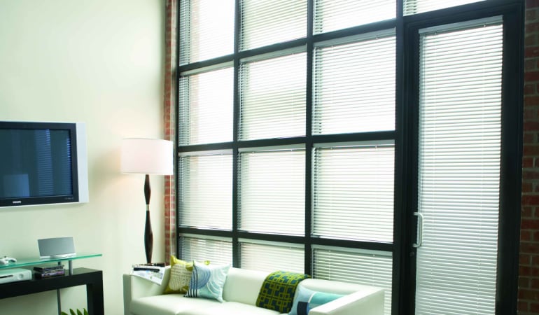 Traditional blinds can become tangled, yellowed, stained, and warped. Metal Blinds in a living room.