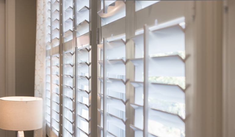East-West windows can have problems with glare from sunrises and sunsets. Plantation shutters close up