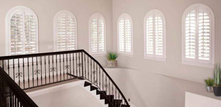 Custom window treatments perfectly cover your window without sticking out and catching on the trim. Arched Plantation Shutters