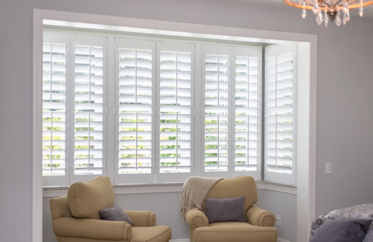 North-South windows may have energy efficiency problems rather than sun glare issues. White plantation shutters in sitting area