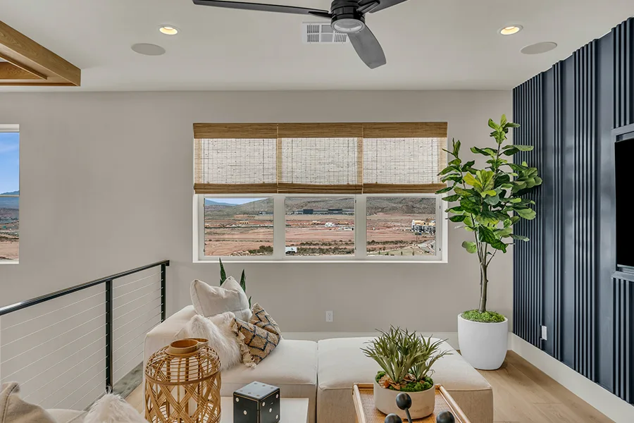Cincinnati homeowners who want eco-friendly home fixtures should consider natural woven shades. Natural brown woven shades on a window in a stylish sitting area