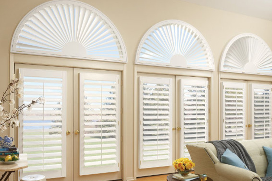 Custom window treatments are unique and adds value to your home. White Polywood shutters on glass doors and custom-made windows.