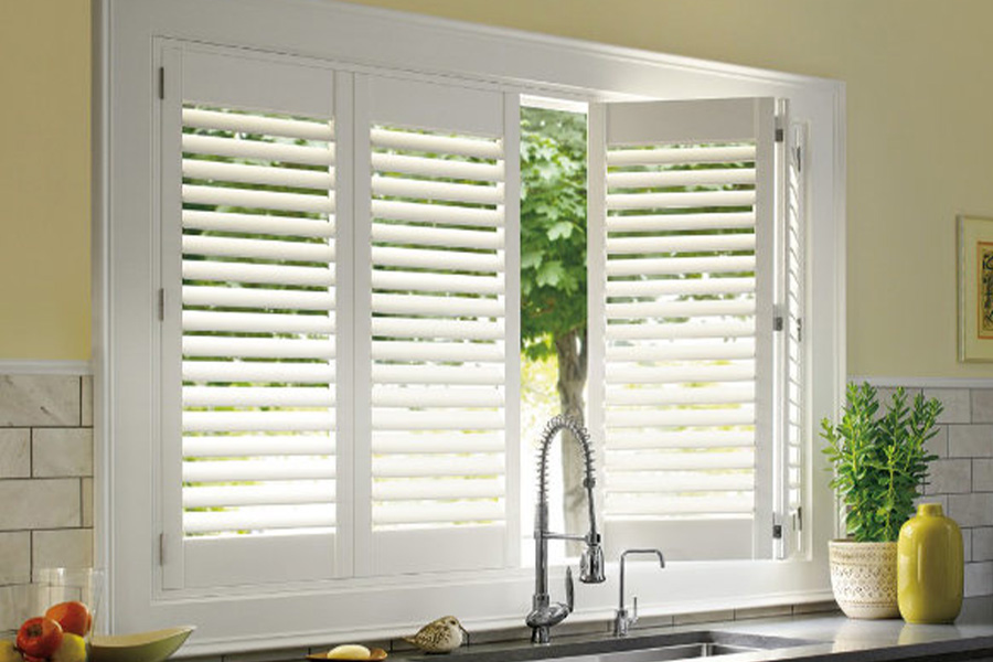 Polywood shutters are built to withstand the test of time in Cincinnati. White Polywood shutters above a kitchen sink.